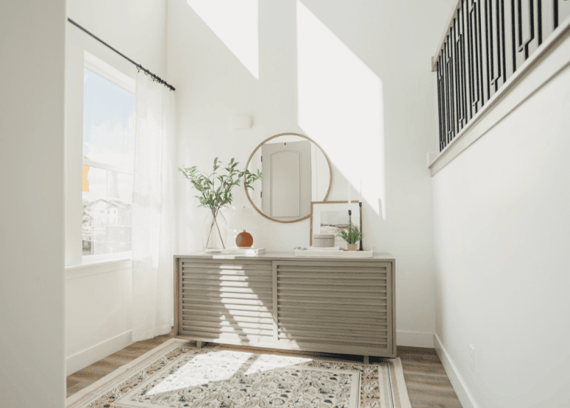 A bright, modern entryway with good home interior lighting and spring decorations for home
