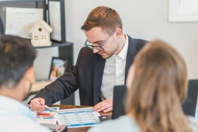 A loan officer reviews a traditional home loan with buyers