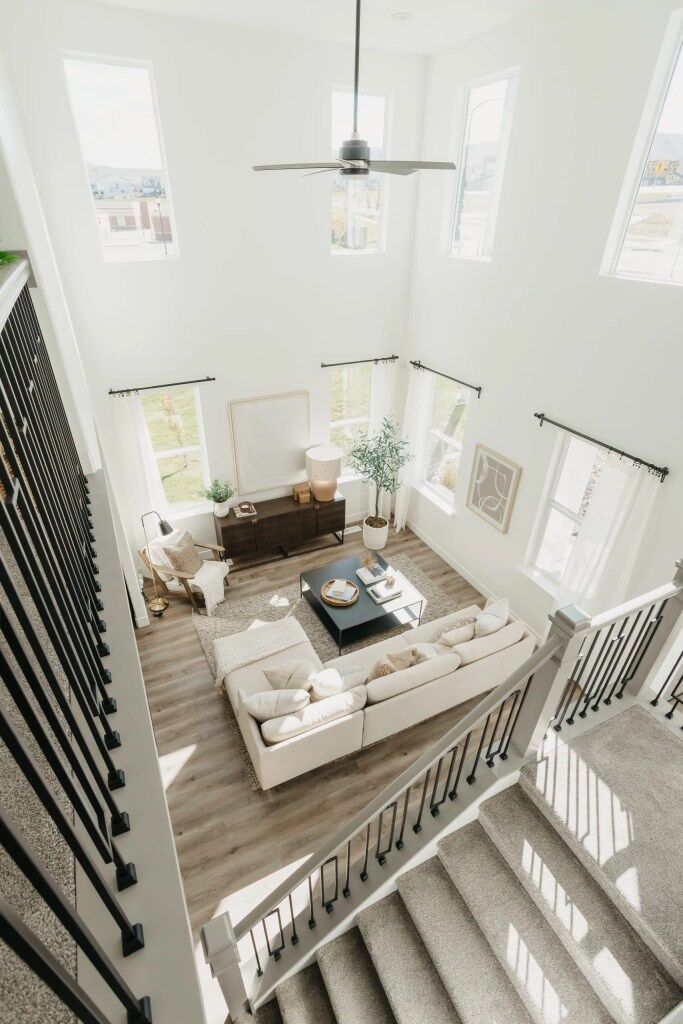 Top view of a spacious open floor plan, including a living room with large windows and a cozy seating area