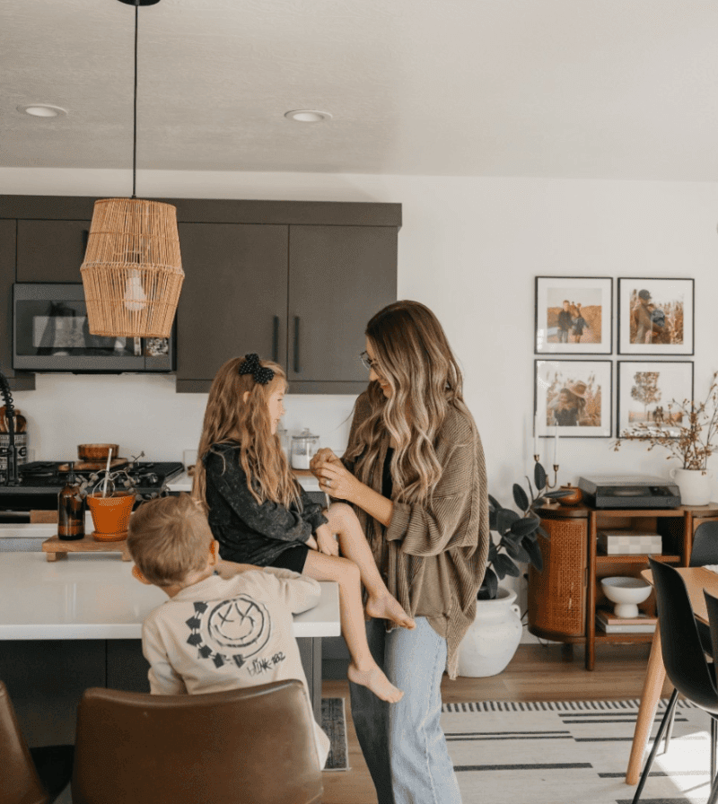A mom and her two young kids in the kitchen of their new home