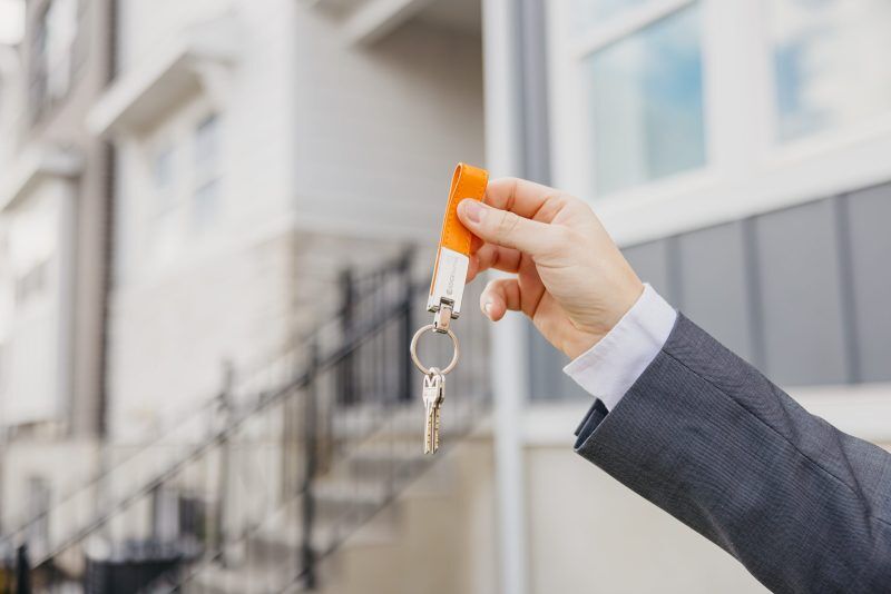 someone holding up a set of EDGEhomes keys